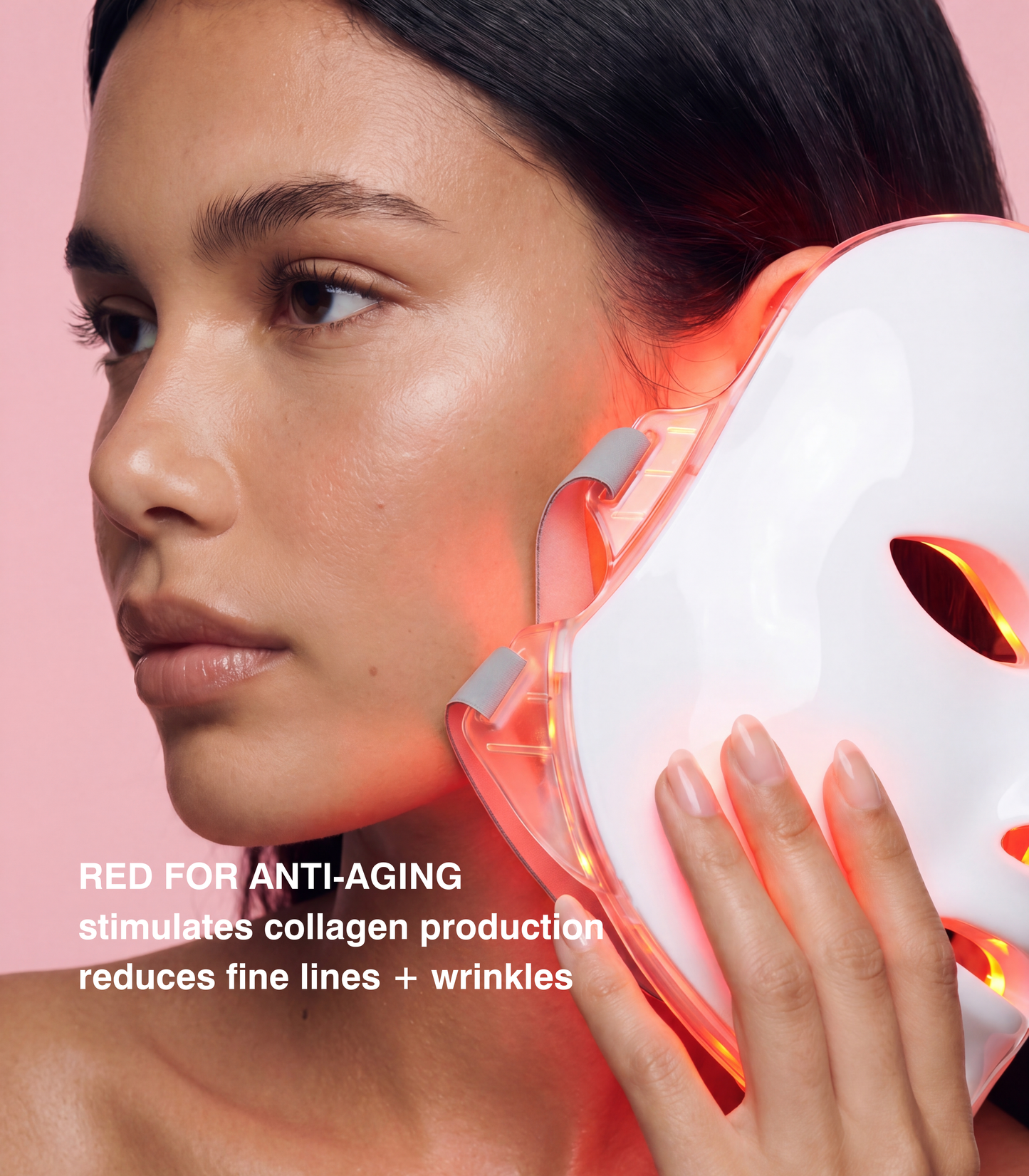 A woman in profile holds a white LED light therapy mask against her cheek, with red light glowing from the device. Text on the image reads 'RED FOR ANTI-AGING stimulates collagen production reduces fine lines + wrinkles' against a soft pink background.